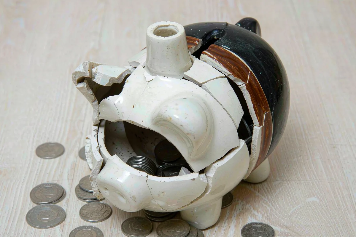Broken piggy bank with coins