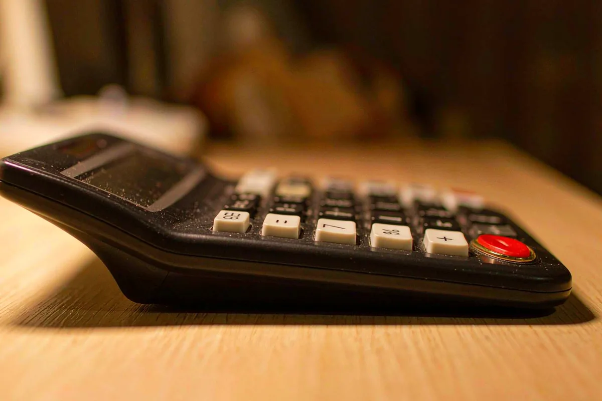 Close-up of a desktop calculator on a wooden desk