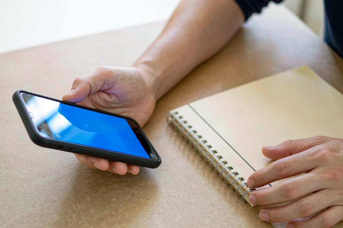 Hands holding a smartphone with a banking app open