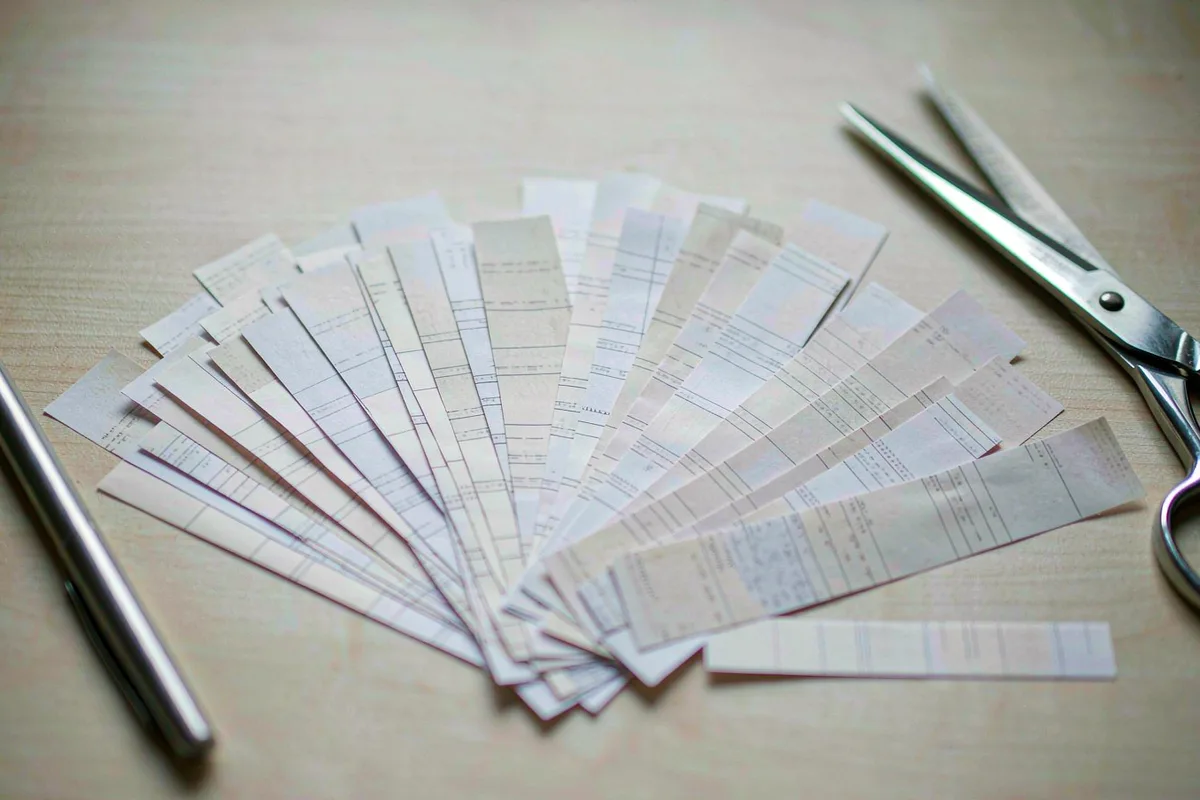 Fan of paper receipts spread across a desk