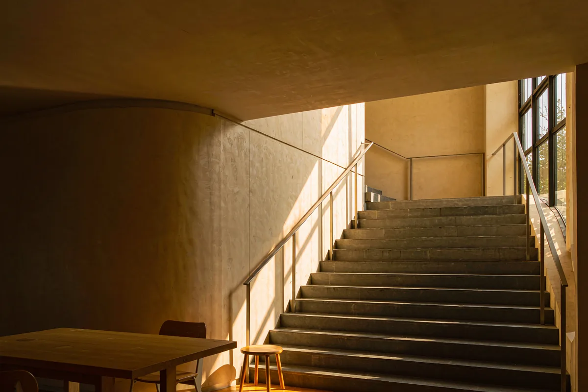 Bright staircase ascending toward warm light